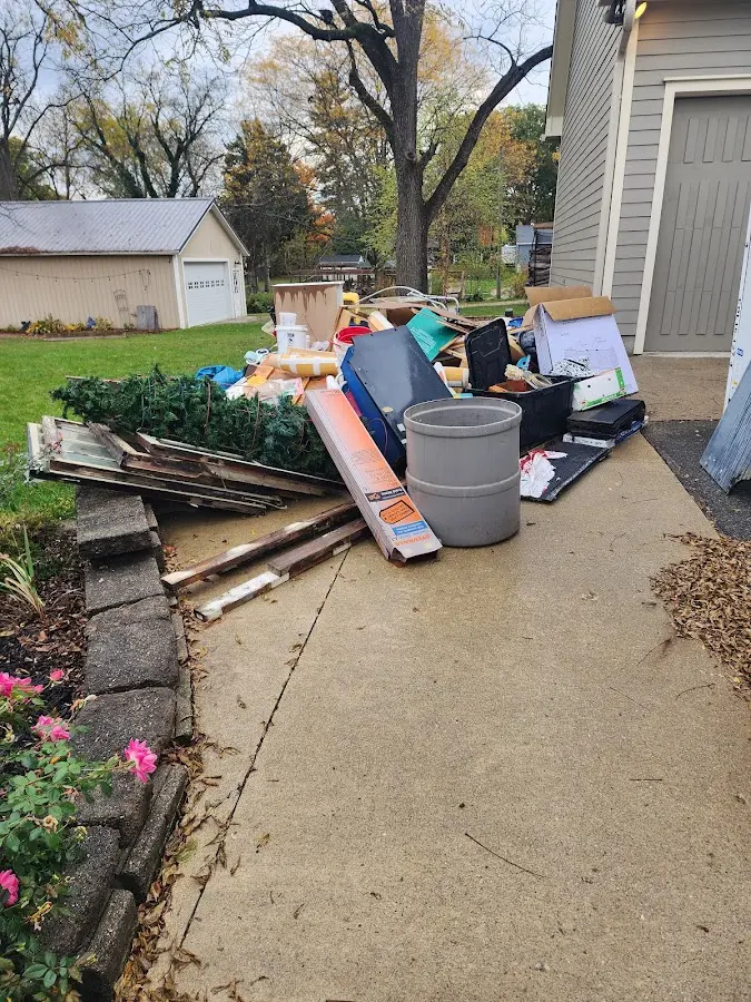 Dumpster being loaded with debris for 12 Yard Dumpster Rental in Sylvan
